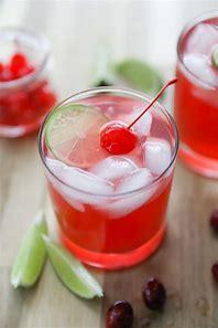 image of a mocktail with a wedge of lime and a cherry on top