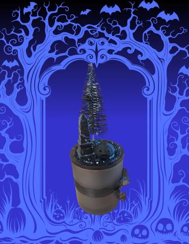 Candle with black pumpkin tree and grave stone on top