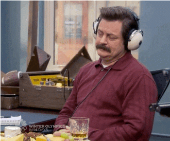 Ron Swanson listening to something with headphones