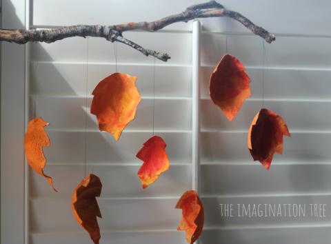 Cardboard leaves hanging from fake branch