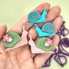 Clay snails held in someone's hand