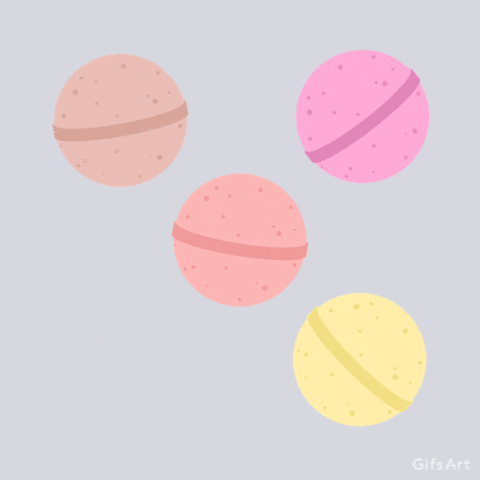 Four bath bombs of different colors shaking