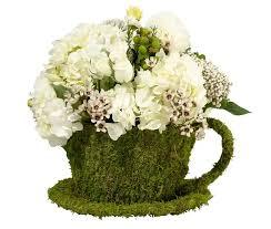 moss teacup with floral arrangement