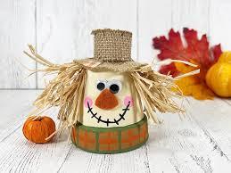 Flowerpot turned into smiling scarecrow face